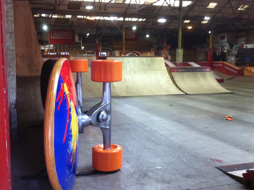 A model of a large skateboard on it's side in a skate park