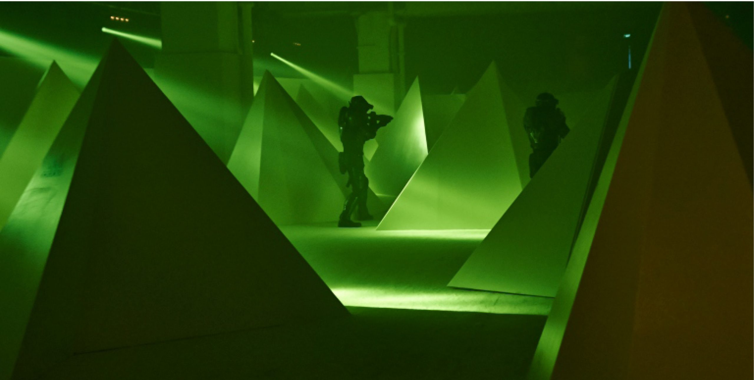 2 people shooting in green lighting