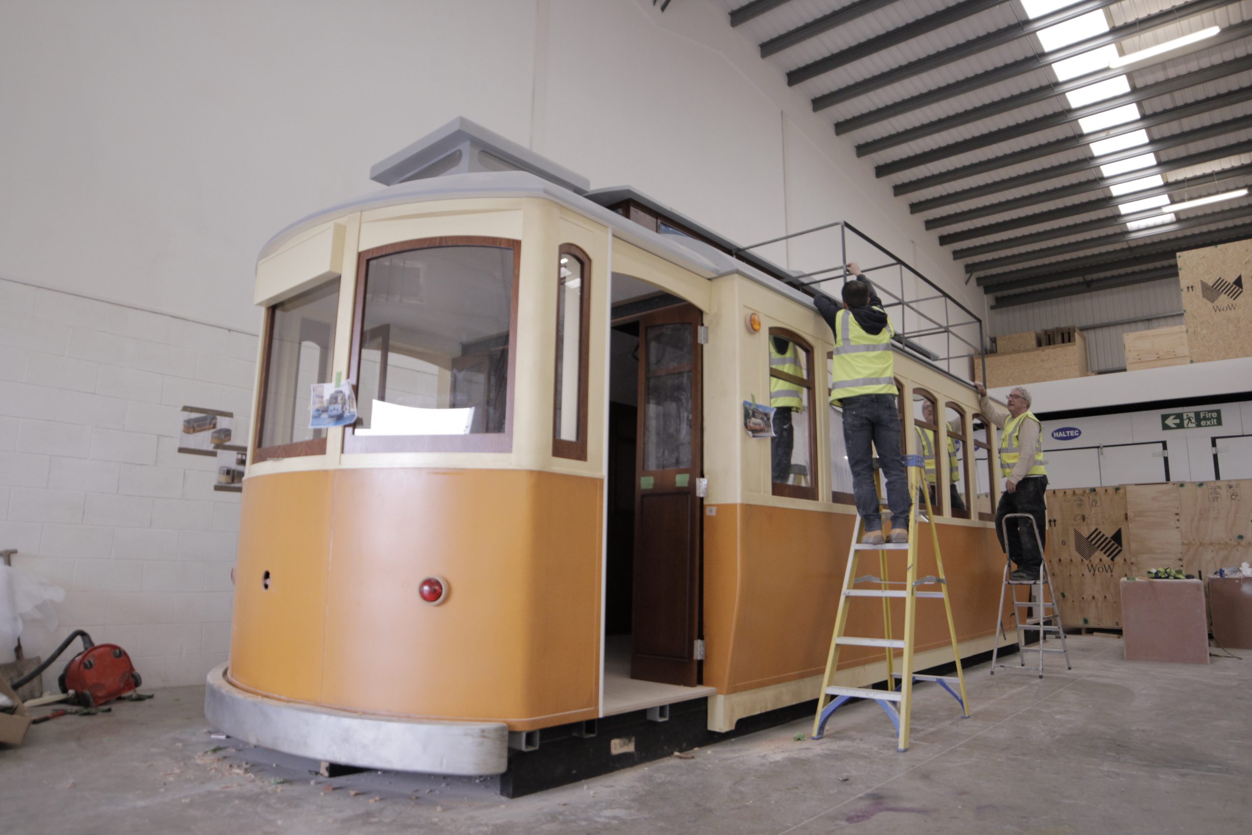 People constructing an orange carriage