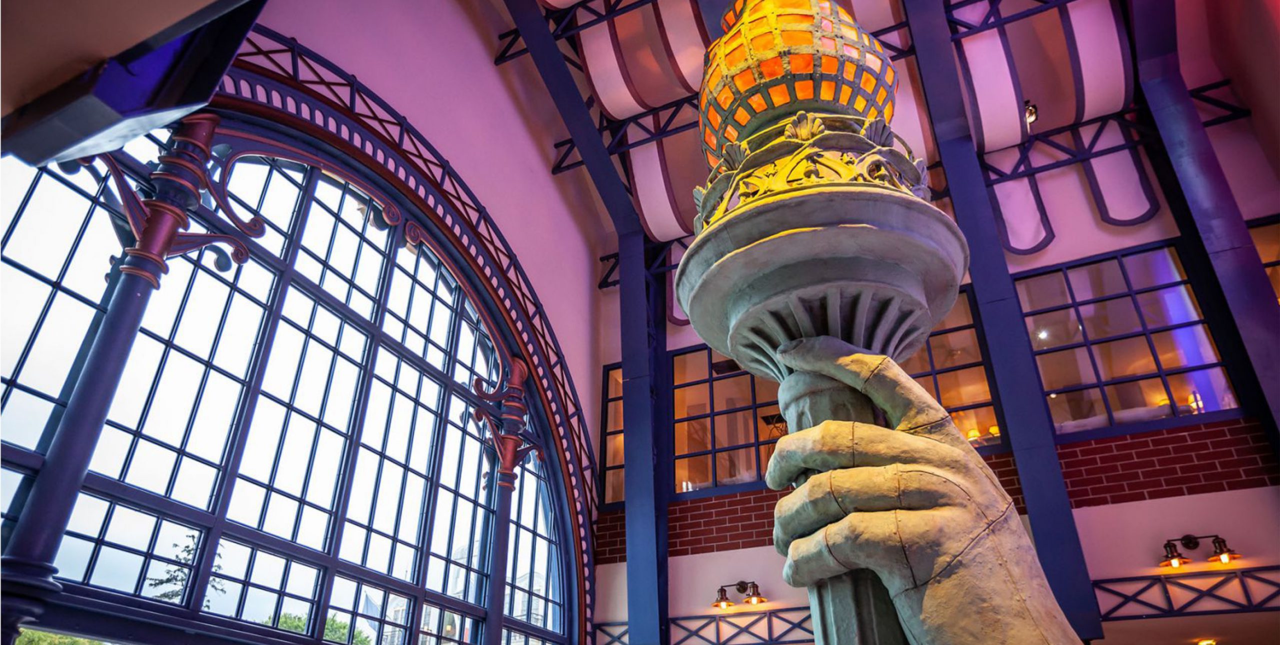 Staute of liberty hand and torch inside a building