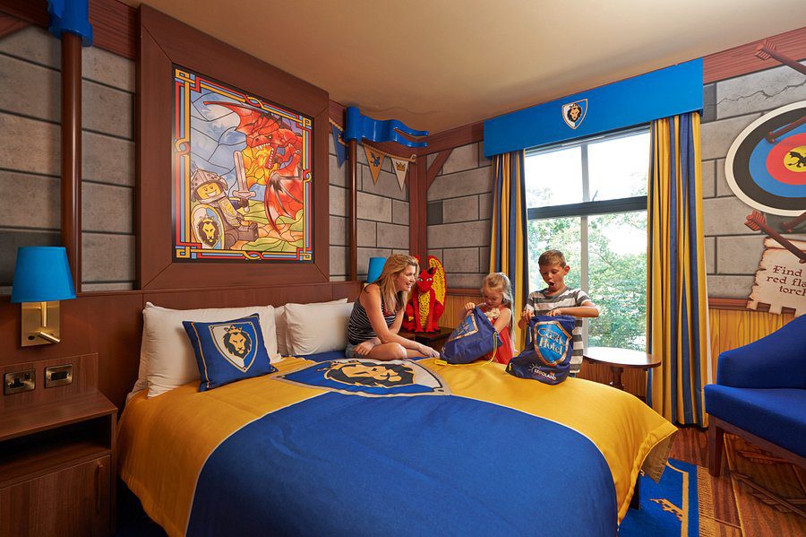 A LEGO castle themed hotel room with 3 people inside