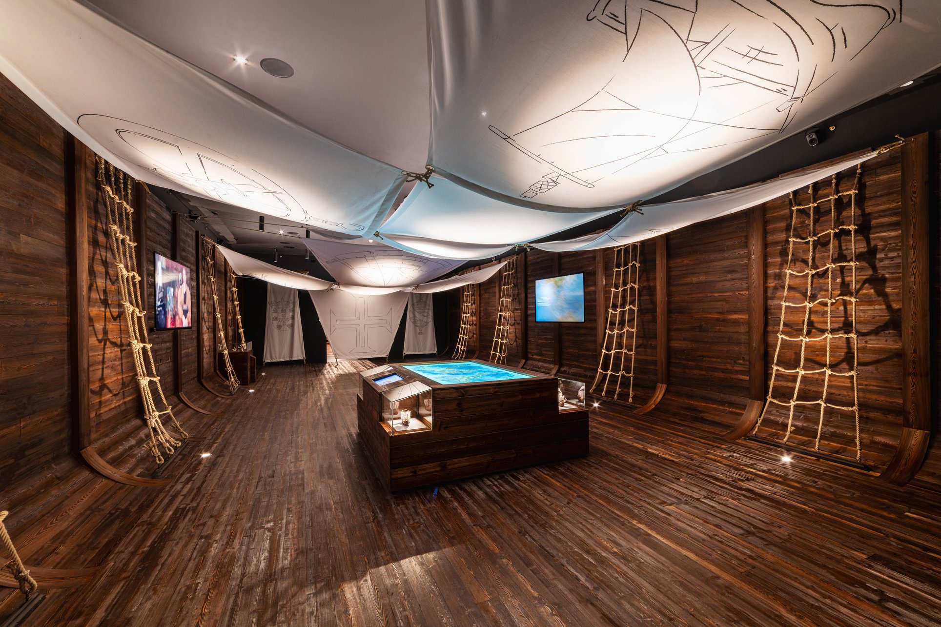 A room made to look like a ship with a display table in the middle
