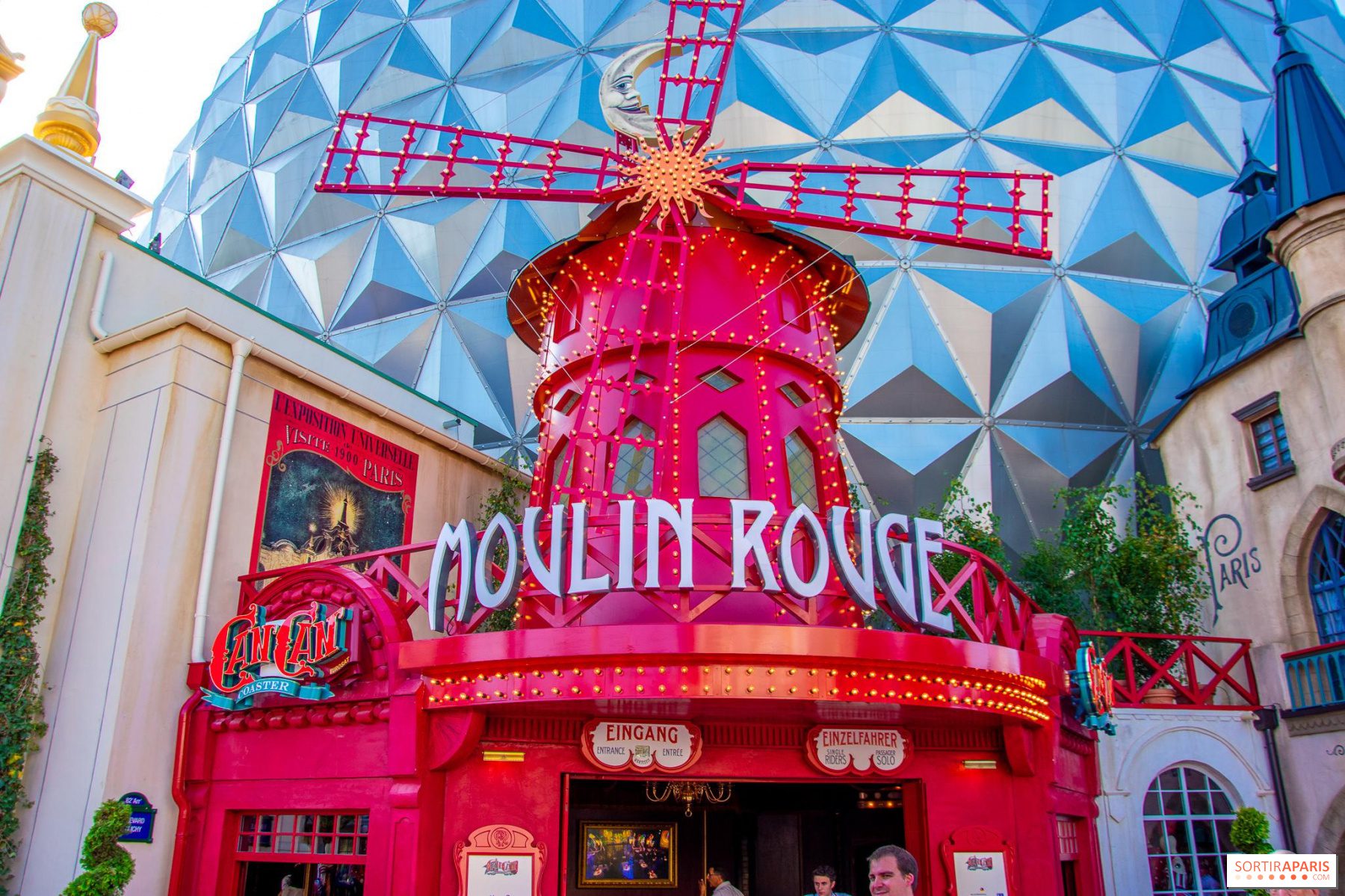 The entrance to a Moulin Rouge attraction with a windmill on top