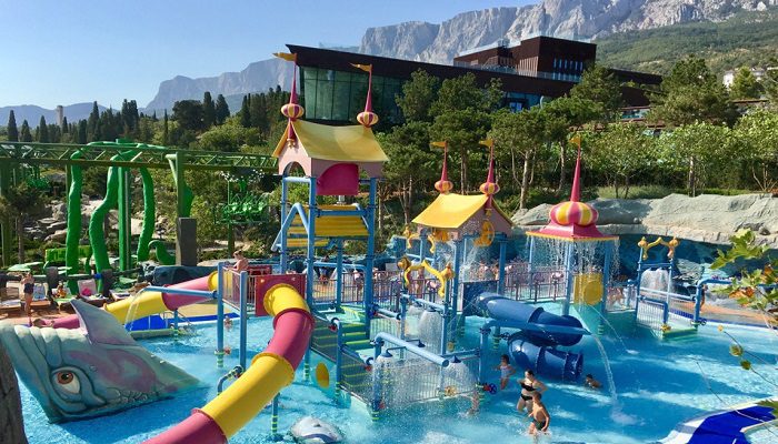 A waterpark area with slides and a climbing area