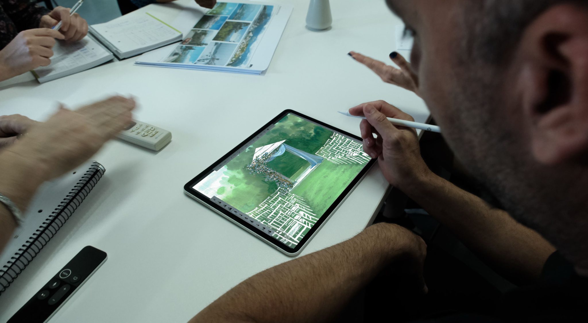A person at a desk creating concept art on a tablet