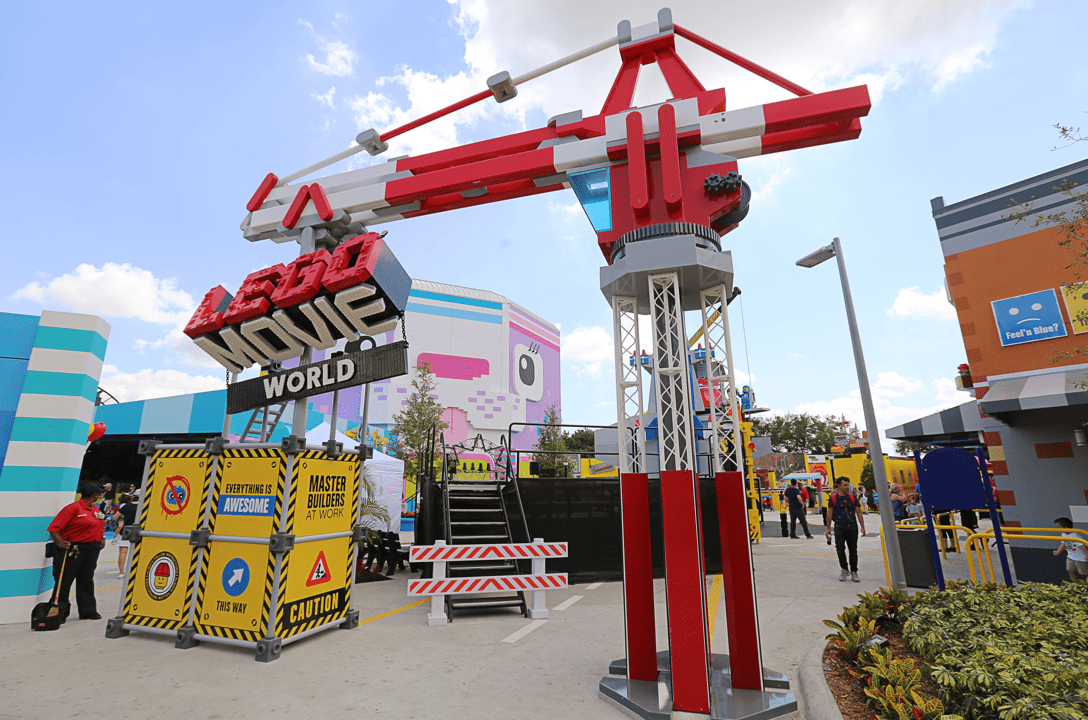 The entrance to LEGO movie world with a crane made out of LEGO holding the sign