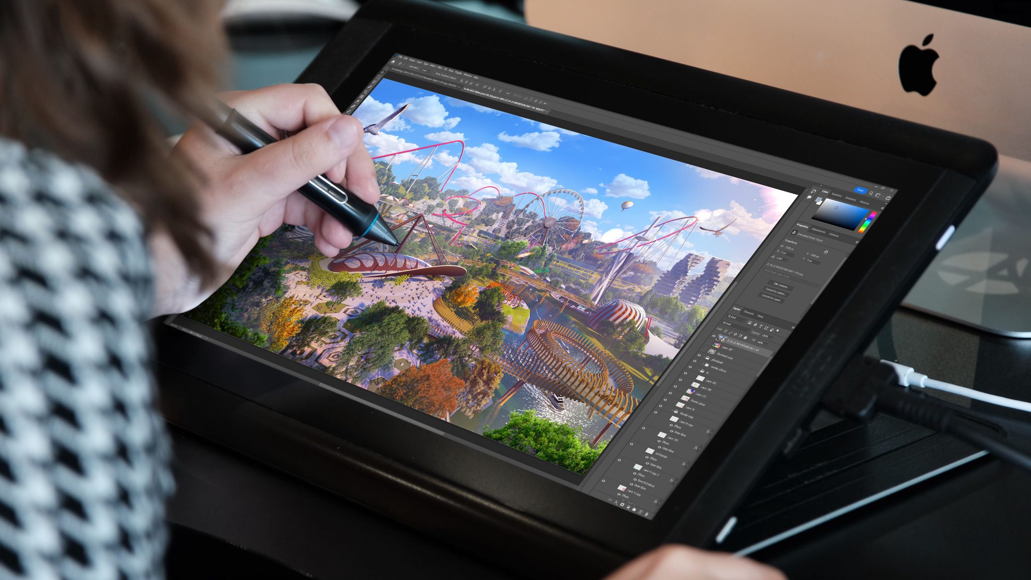 A persons hand drawing a concept art image on a tablet of a themed area with red rides in the background