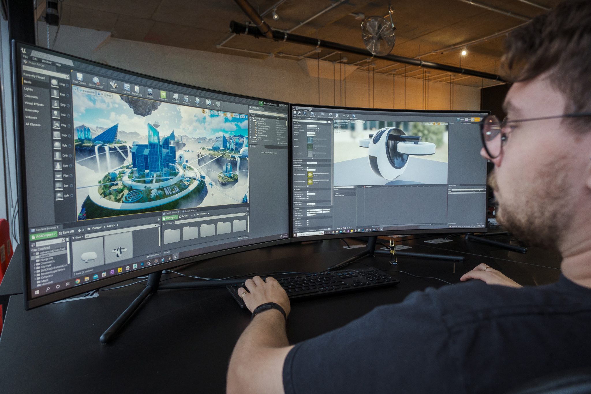 A person sitting in front of 2 computer monitors using Unreal Engine to create Concept images