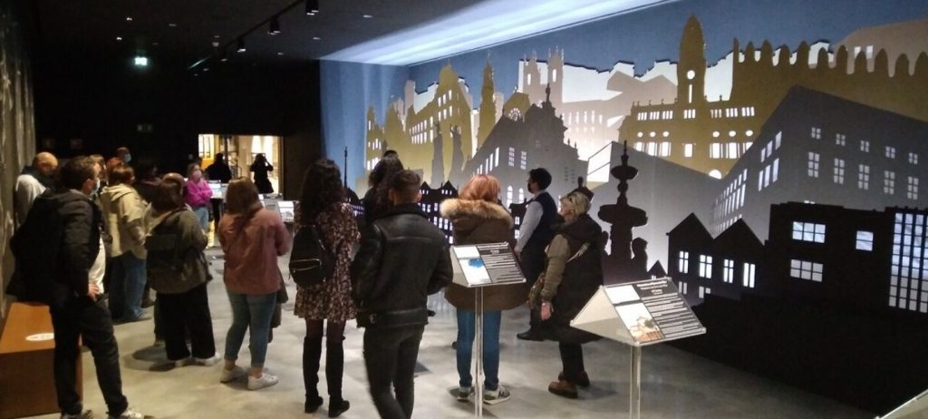people gathering to look at an exhibition 