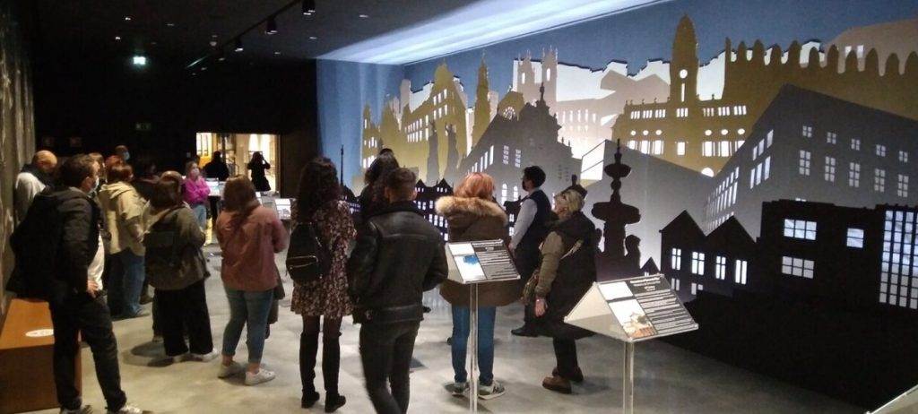 people gathering to look at an exhibition