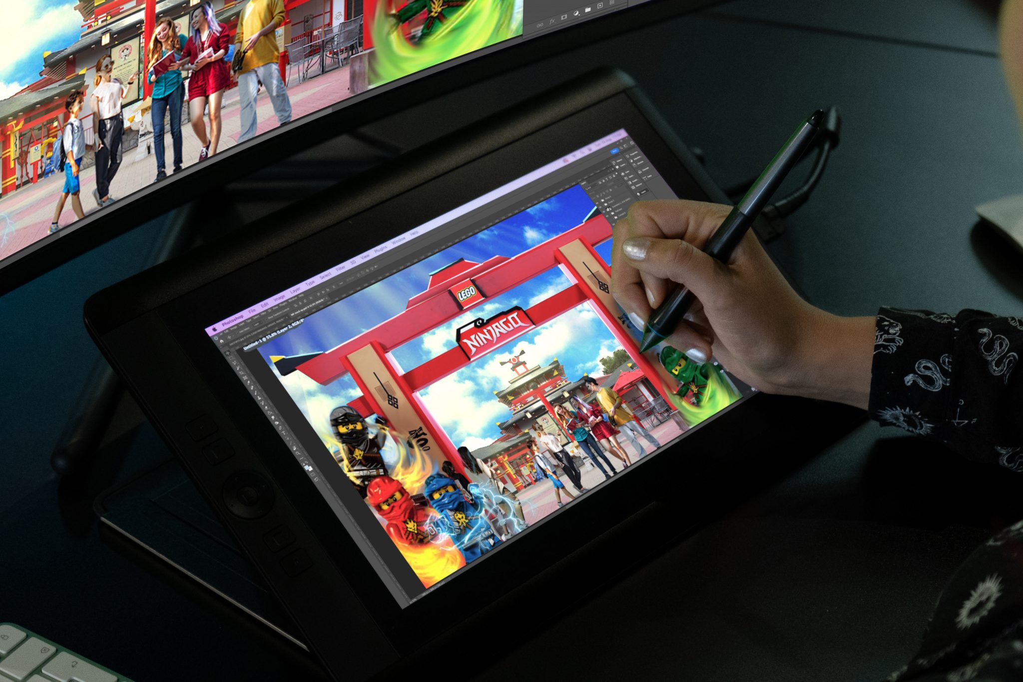 A persons hand drawing on a tablet an image of LEGO ninjago