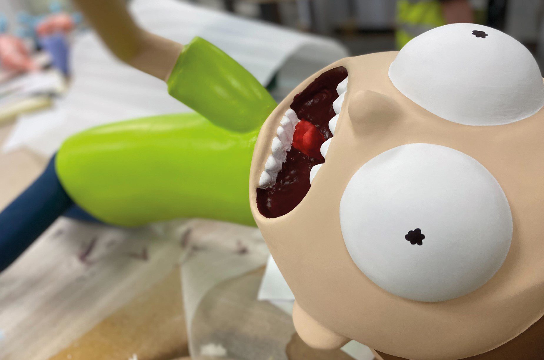 A close-up of a Morty figure that has a green t-shirt and its mouth open